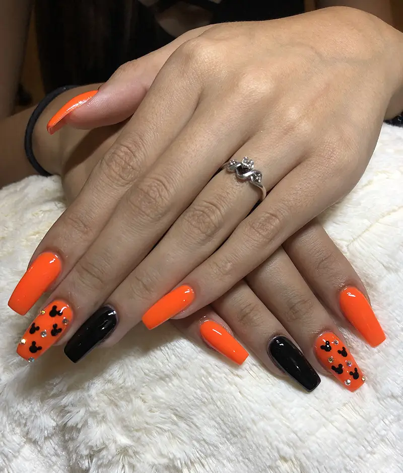 Orange and black Disney nails for Halloween