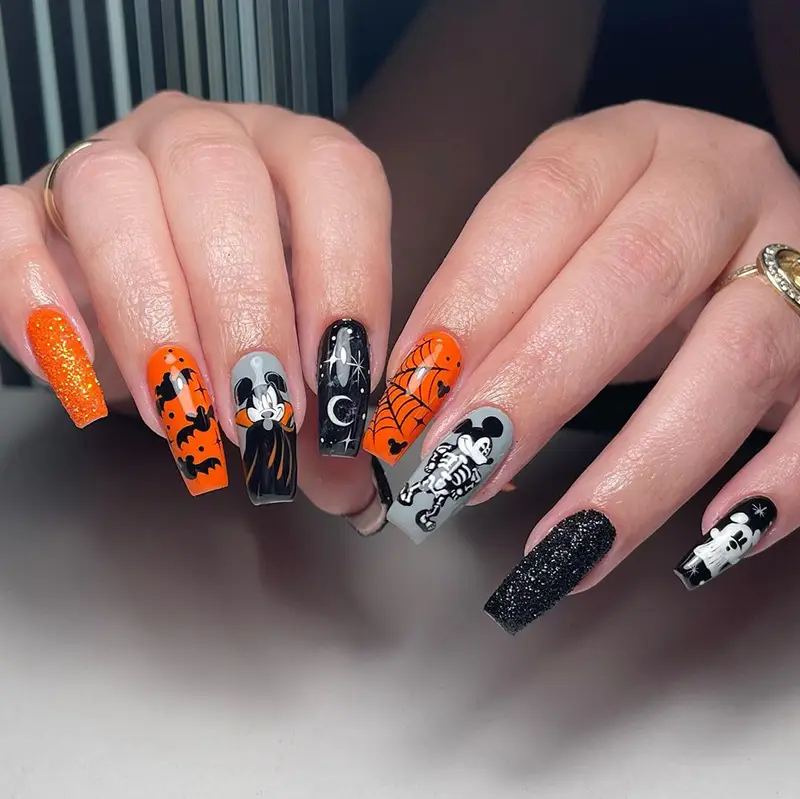 Disney Halloween nails featuring Mickey Mouse as a vampire, skeleton, and ghost.