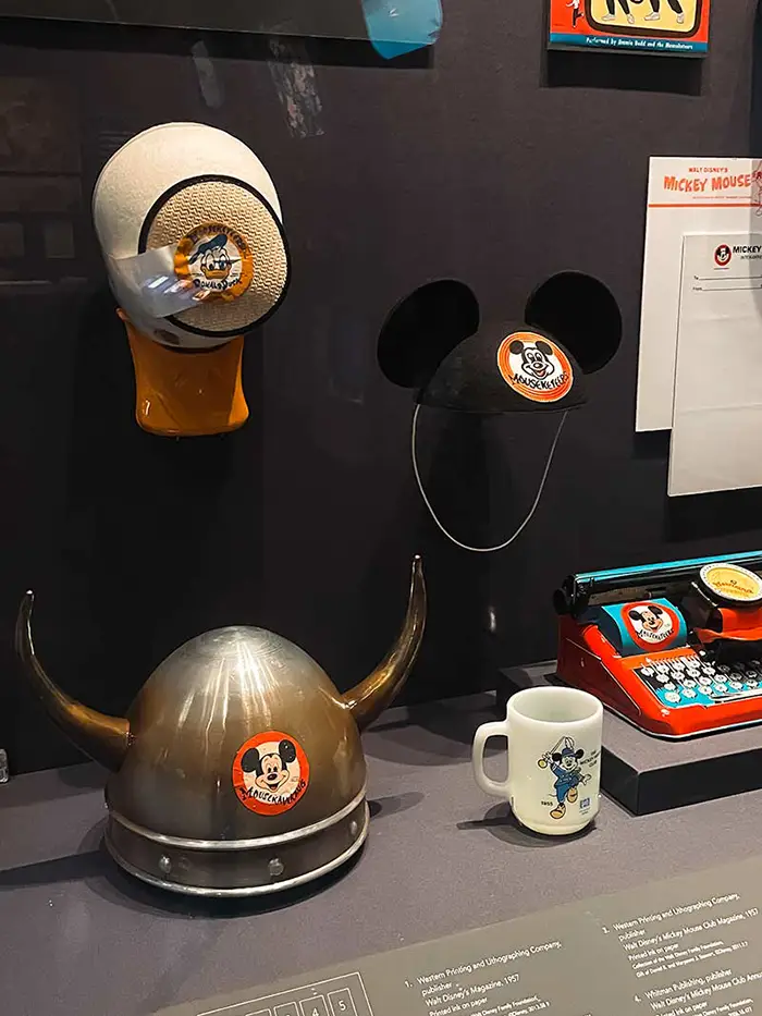 Walt Disney Family Museum display showing Mickey Mouse Ears, Vikin Mickey hat, and Donald Duck hat.
