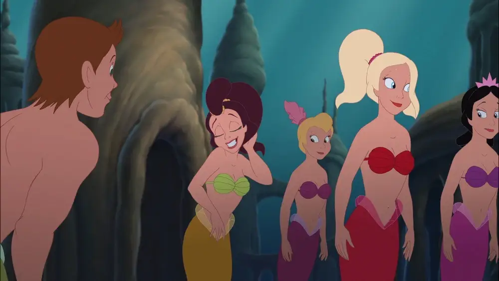 The Little Mermaid’s Adella primping in front of a boy mermaid.