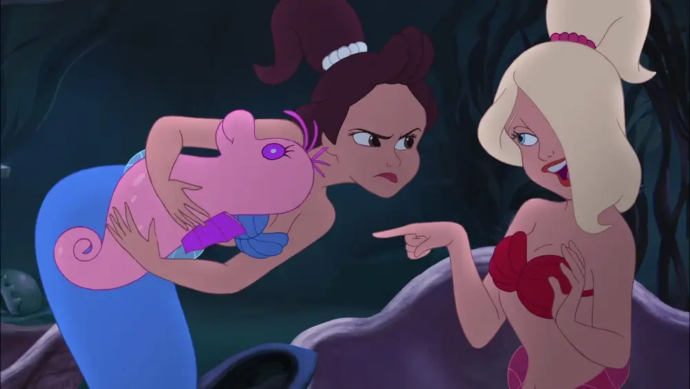 The Little Mermaid’s Aquata grimaces at Arista for taking her stuffed animal. 