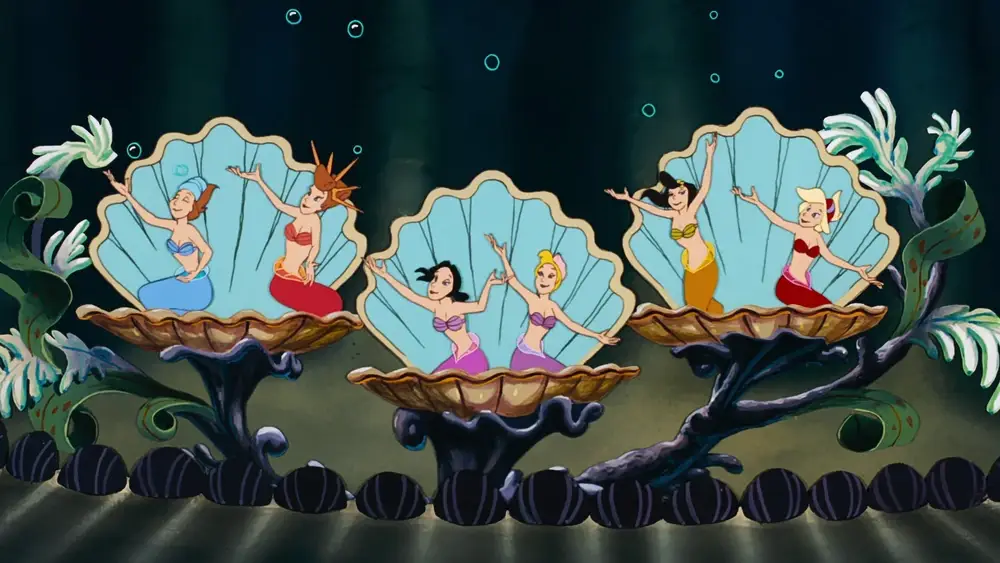 Scene from The Little Mermaid where Attina, Alana, Adella, Aquata, Arista, and Andrina are sitting in seashells. 