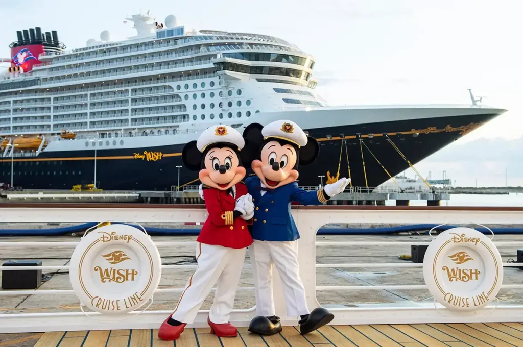 Mickey and Minnie in front of DIsney Wish cruise ship.